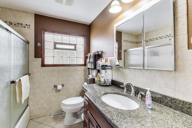 full bath featuring visible vents, tile walls, tile patterned flooring, vanity, and toilet