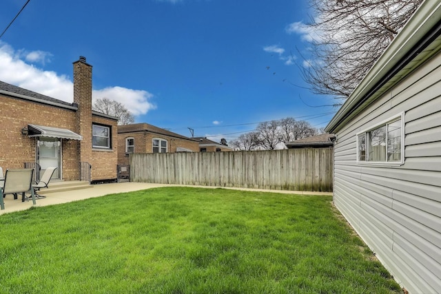 view of yard with fence and a patio area