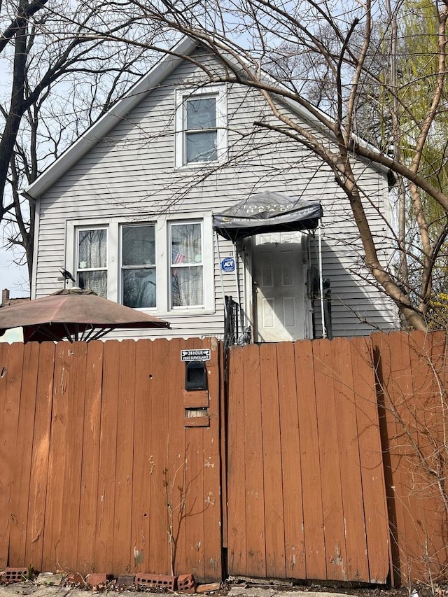 view of front of home featuring fence