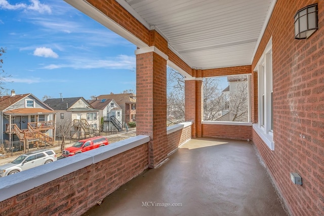 view of patio / terrace with a residential view and a balcony