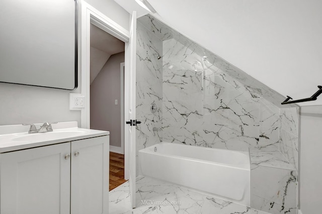 bathroom with vanity, bathing tub / shower combination, and lofted ceiling