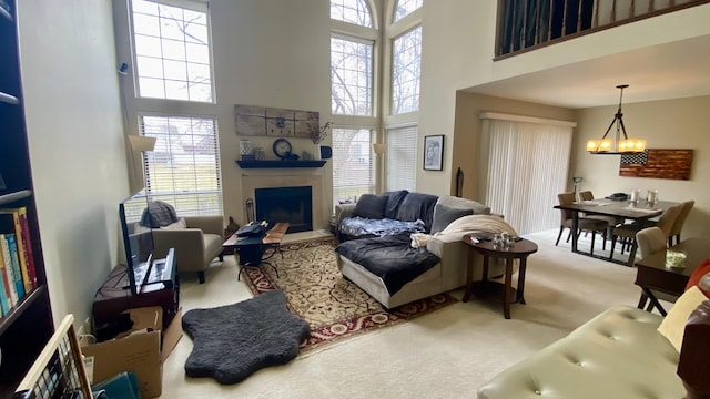 4434 Edinburg Ln Unit 0, Hanover Park, IL 60133 - carpeted living area featuring a high ceiling, a chandelier, and a fireplace