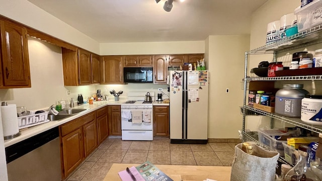 4434 Edinburg Ln Unit 0, Hanover Park, IL 60133 - kitchen with light tile patterned floors, light countertops, brown cabinetry, and white appliances