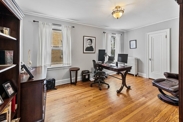 office space with radiator heating unit, baseboards, ornamental molding, and light wood finished floors
