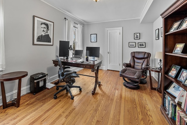 office space featuring light wood-style floors, baseboards, and crown molding