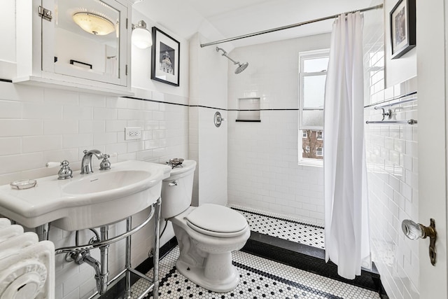 full bath featuring tile patterned flooring, tile walls, toilet, and a shower stall