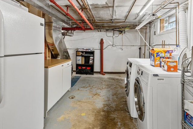 below grade area with freestanding refrigerator and independent washer and dryer