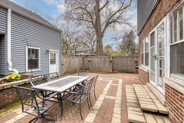 view of patio / terrace featuring a fenced backyard, outdoor dining area, and french doors