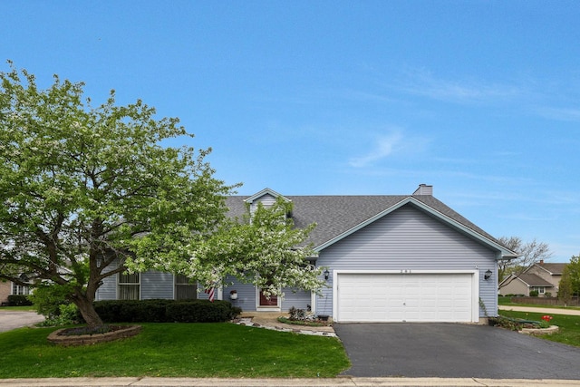 view of property hidden behind natural elements with driveway, a chimney, a garage, a front lawn, and a shingled roof