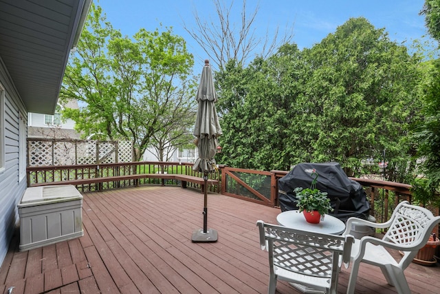wooden deck with a grill