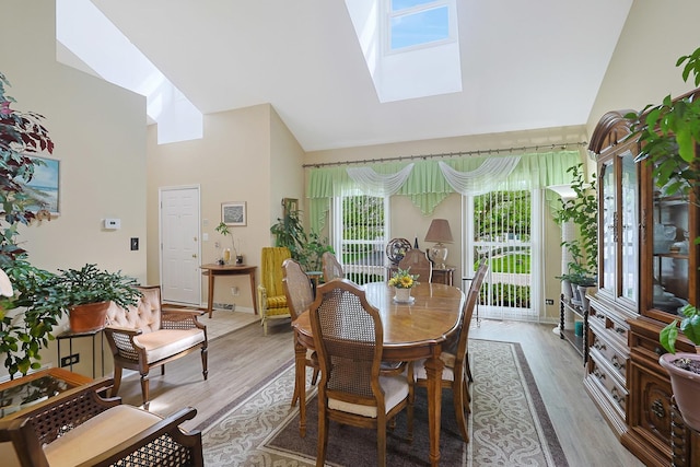 281 Windsor Dr, Bartlett, IL 60103 - dining area with high vaulted ceiling, a skylight, and light wood-type flooring