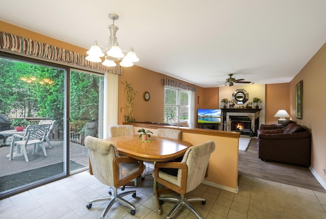 281 Windsor Dr, Bartlett, IL 60103 - dining room featuring light tile patterned flooring, a tiled fireplace, and ceiling fan with notable chandelier