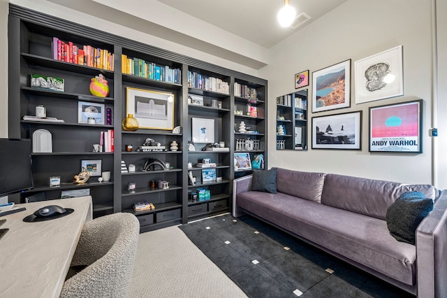 interior space featuring dark carpet, built in features, and visible vents