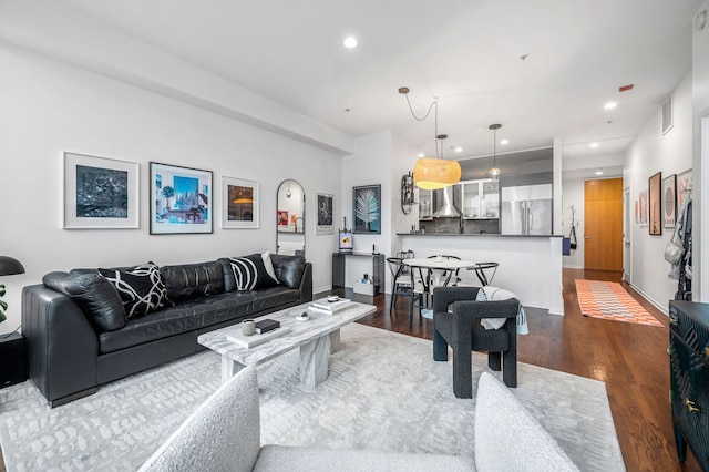 living room with recessed lighting, baseboards, dark wood finished floors, and visible vents