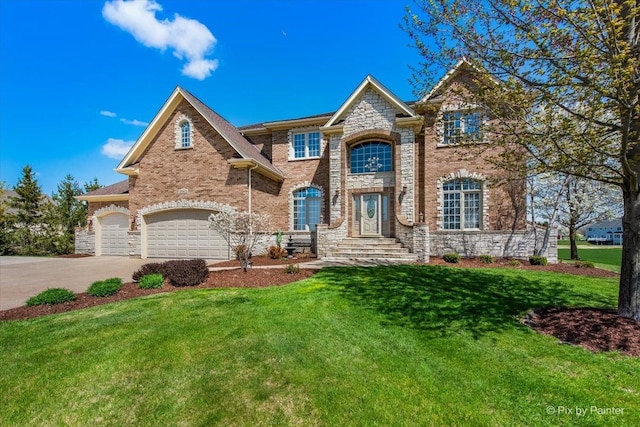 view of front of house featuring a garage, concrete driveway, a front yard, and stone siding