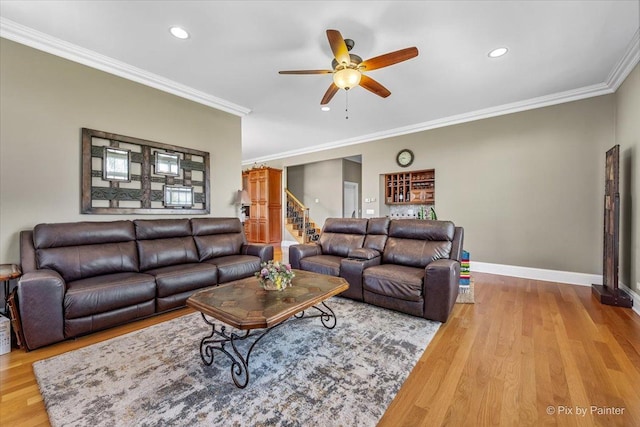 living area with crown molding, ceiling fan, and wood finished floors