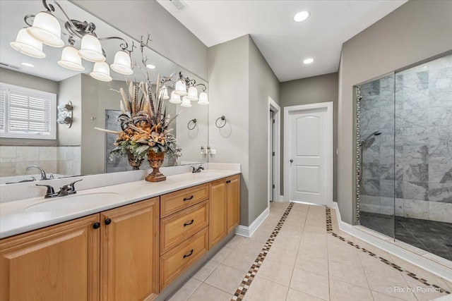full bathroom with a sink, tile patterned flooring, recessed lighting, and tiled shower