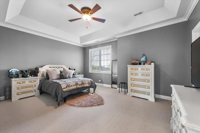 bedroom with visible vents, ornamental molding, light carpet, baseboards, and a raised ceiling