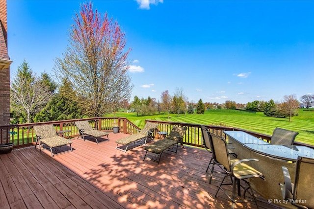 wooden deck featuring a lawn