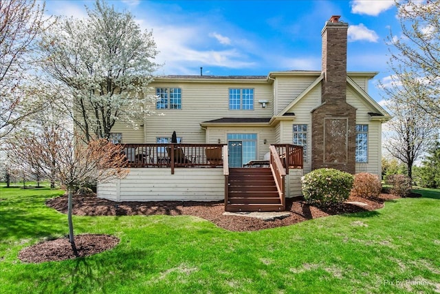 rear view of house featuring stairs, a chimney, a yard, and a deck