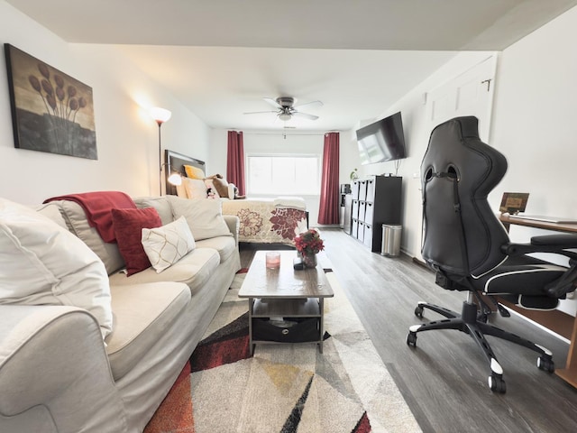 living area featuring ceiling fan and wood finished floors