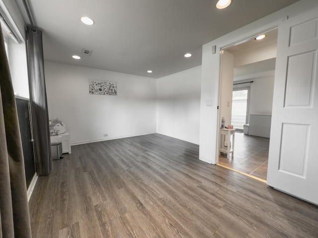 unfurnished room featuring recessed lighting, wood finished floors, and visible vents