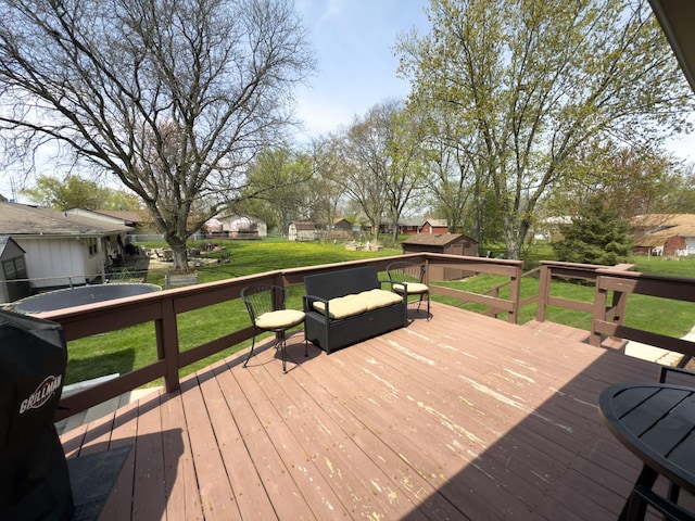 wooden terrace with a lawn and a residential view