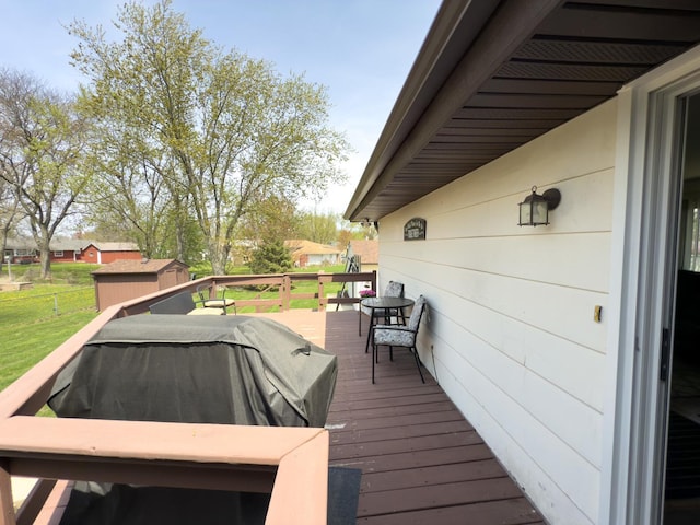 deck with an outbuilding and a shed