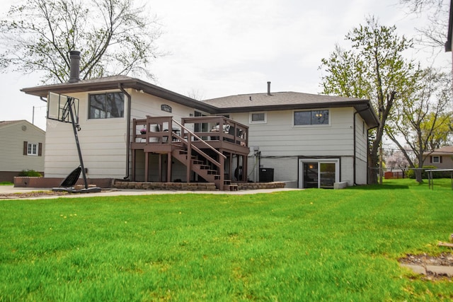 back of house with central AC, a deck, stairs, brick siding, and a yard