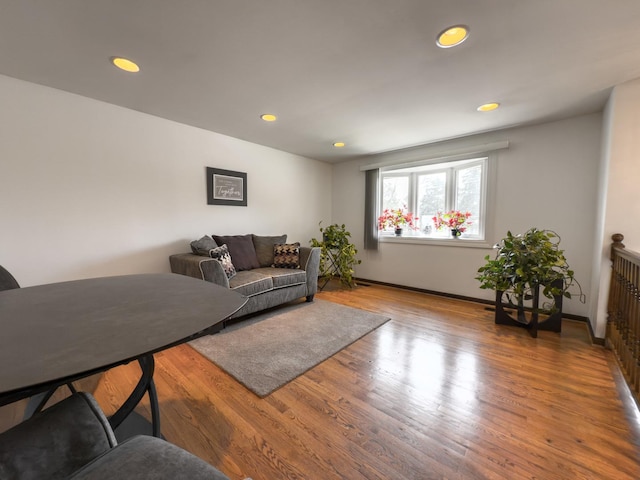 living room with baseboards, recessed lighting, and wood finished floors