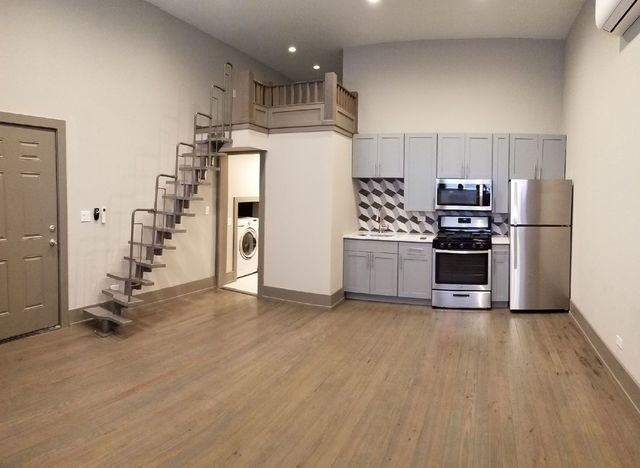 2957 N Avers Ave, Chicago, IL 60618 - kitchen with appliances with stainless steel finishes, gray cabinets, washer / clothes dryer, wood finished floors, and decorative backsplash