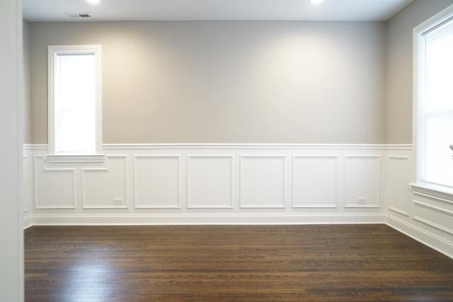 2957 N Avers Ave, Chicago, IL 60618 - empty room featuring wainscoting, dark wood-style floors, a decorative wall, and recessed lighting
