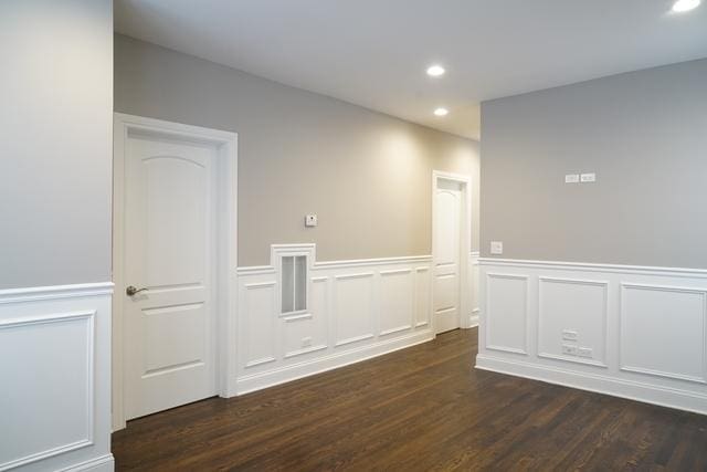 2957 N Avers Ave, Chicago, IL 60618 - empty room with dark wood finished floors, a wainscoted wall, a decorative wall, and recessed lighting