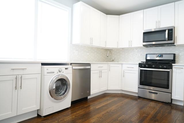 2957 N Avers Ave, Chicago, IL 60618 - kitchen with stainless steel appliances, washer / clothes dryer, light countertops, white cabinets, and a sink