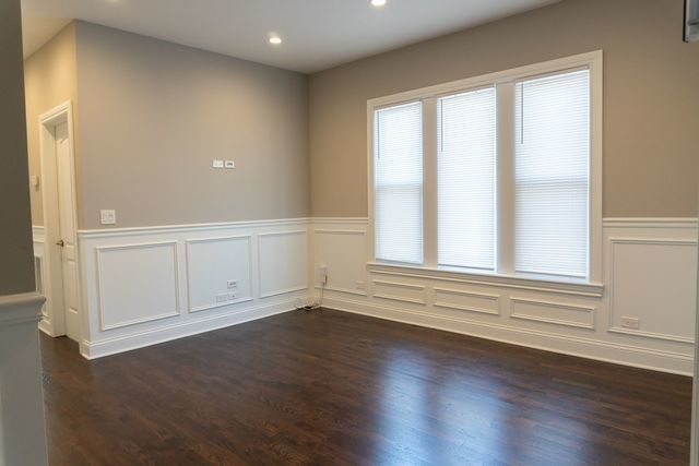 2957 N Avers Ave, Chicago, IL 60618 - empty room featuring wainscoting, recessed lighting, a decorative wall, and dark wood finished floors