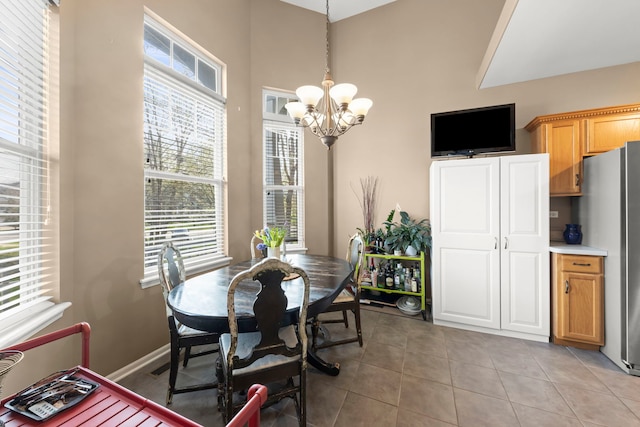 dining space featuring an inviting chandelier and light tile patterned floors