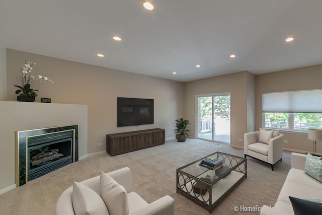 carpeted living room featuring recessed lighting, baseboards, and a fireplace