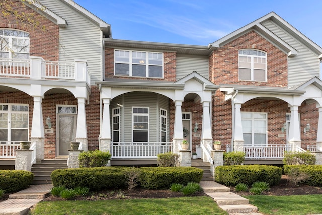 view of front facade with a porch and brick siding