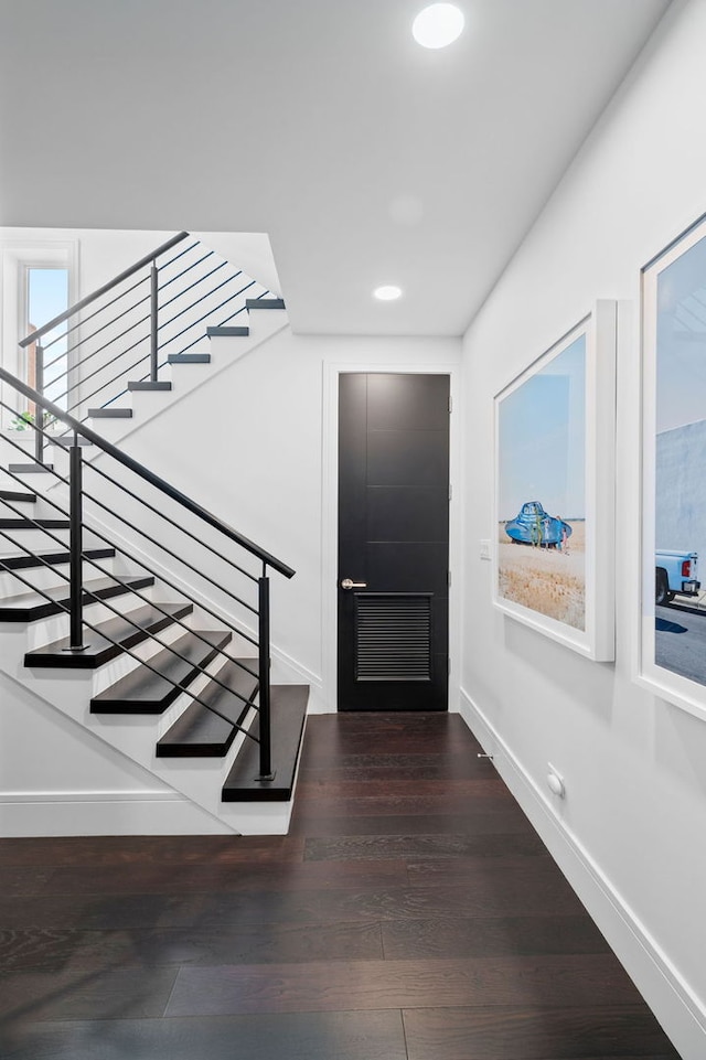 entrance foyer featuring baseboards, recessed lighting, stairs, and wood finished floors