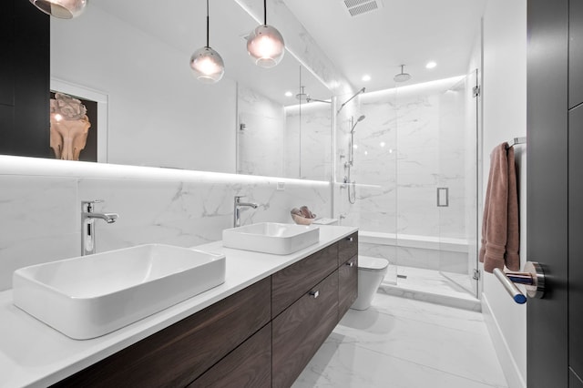 bathroom featuring visible vents, recessed lighting, marble finish floor, and a sink