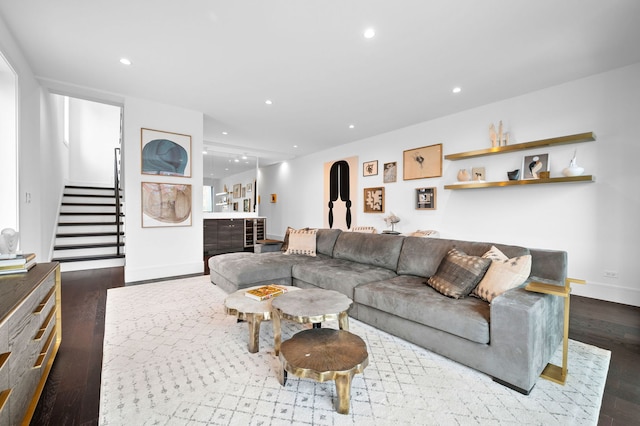 living room featuring recessed lighting, baseboards, stairs, and wood finished floors