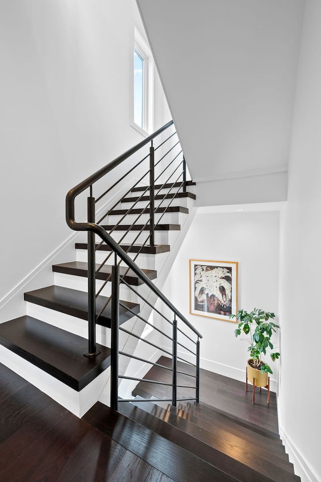 stairs featuring baseboards and wood finished floors