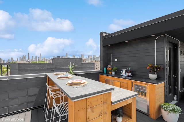 view of patio featuring a view of city, outdoor wet bar, and wine cooler