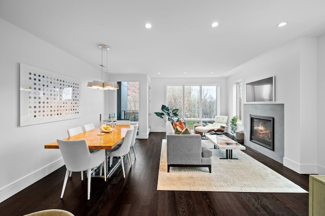living room with recessed lighting, baseboards, and a tiled fireplace