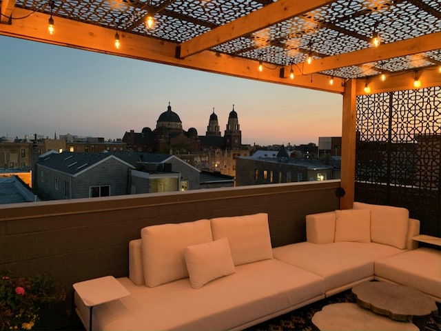 view of patio with a city view, a pergola, outdoor lounge area, and a balcony