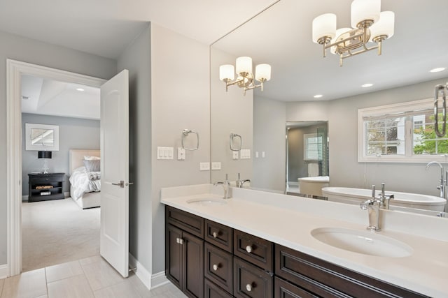 840 S Madison St, Hinsdale, IL 60521 - full bath with a chandelier, double vanity, a soaking tub, baseboards, and ensuite bath