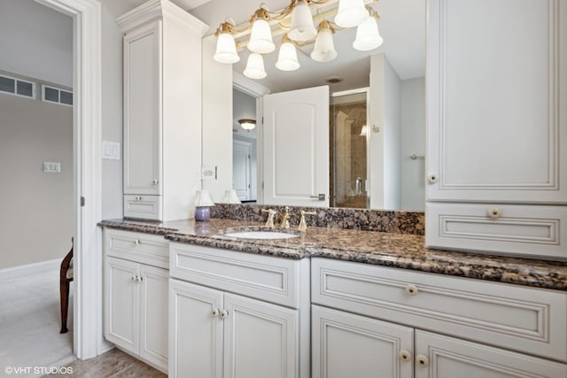 840 S Madison St, Hinsdale, IL 60521 - bathroom with vanity, a chandelier, a stall shower, and baseboards
