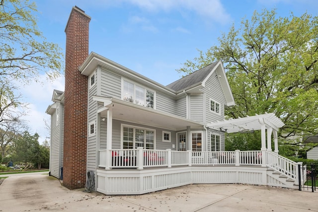840 S Madison St, Hinsdale, IL 60521 - back of property featuring a chimney, a wooden deck, a pergola, and a patio