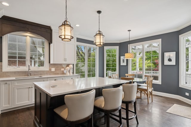 840 S Madison St, Hinsdale, IL 60521 - kitchen with a sink, light countertops, a center island, decorative backsplash, and white cabinetry