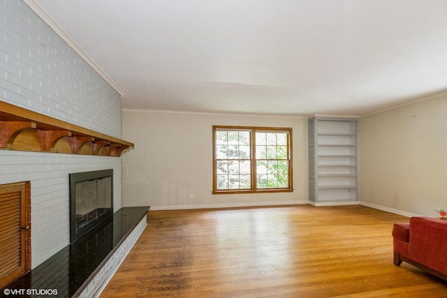 10740 S Drew St, Chicago, IL 60643 - unfurnished living room with light wood-type flooring, ornamental molding, a brick fireplace, and built in shelves
